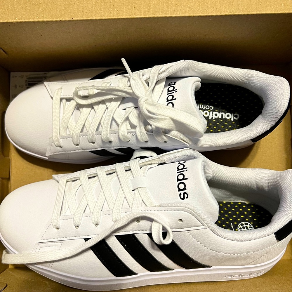 Women’s white adidas with black stripes size 9. Brand new, only worn to try on.
